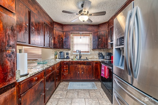 1103 E 43rd St, San Angelo, TX 76903 - kitchen featuring stainless steel fridge, stove, a textured ceiling, a ceiling fan, and tasteful backsplash