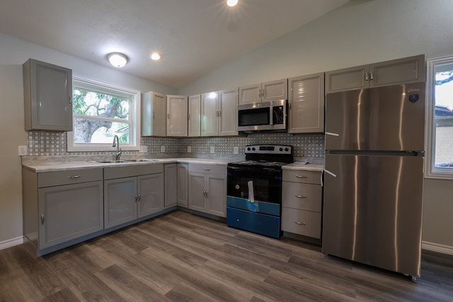 614 Coates St, Ozona, TX 76943 - kitchen with stainless steel appliances, a sink, gray cabinetry, and vaulted ceiling