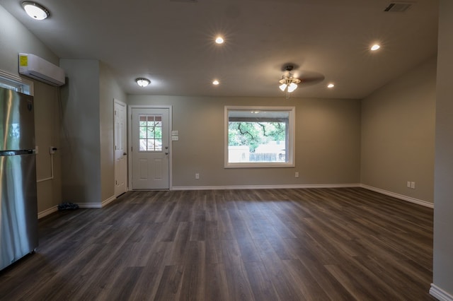 614 Coates St, Ozona, TX 76943 - foyer featuring an AC wall unit, dark wood finished floors, baseboards, and recessed lighting