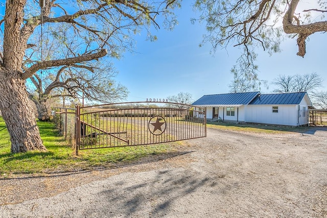 view of gate with a yard