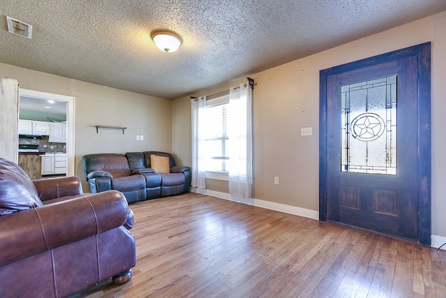 entrance foyer featuring light hardwood / wood-style flooring and a textured ceiling