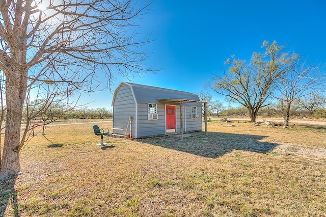 view of outbuilding featuring a yard