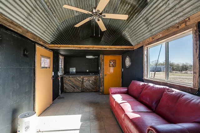 living room featuring ceiling fan, tile patterned flooring, and vaulted ceiling