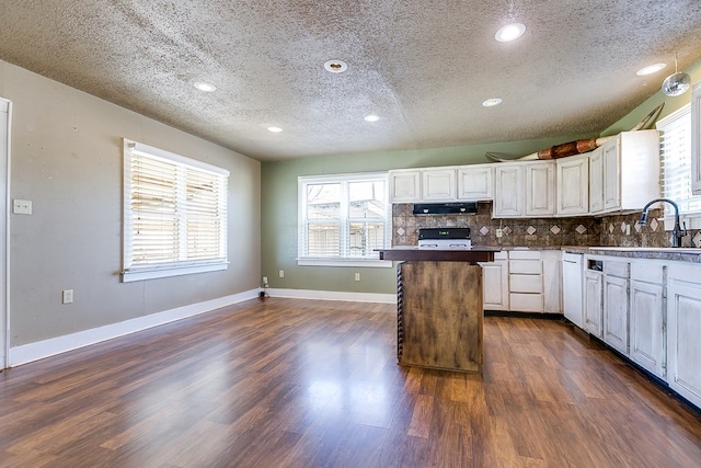 kitchen featuring decorative backsplash, sink, a textured ceiling, and white cabinets