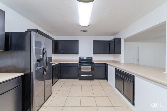 kitchen with light tile patterned floors, black range with electric cooktop, a textured ceiling, stainless steel fridge with ice dispenser, and kitchen peninsula