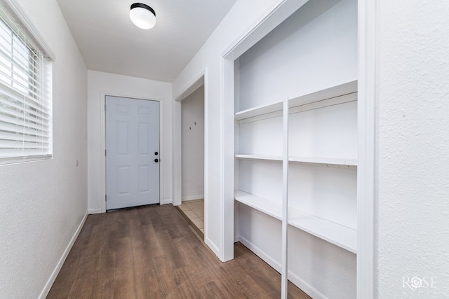 corridor with dark wood-type flooring