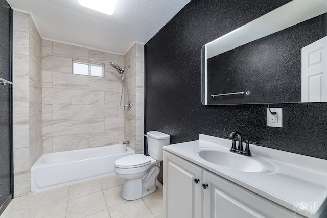 full bathroom with tile patterned floors, toilet, tiled shower / bath, a textured ceiling, and vanity