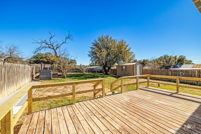 deck with a storage shed and a lawn