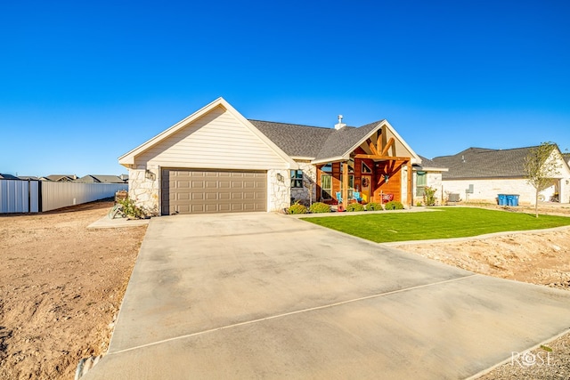 view of front of property featuring a garage and a front lawn