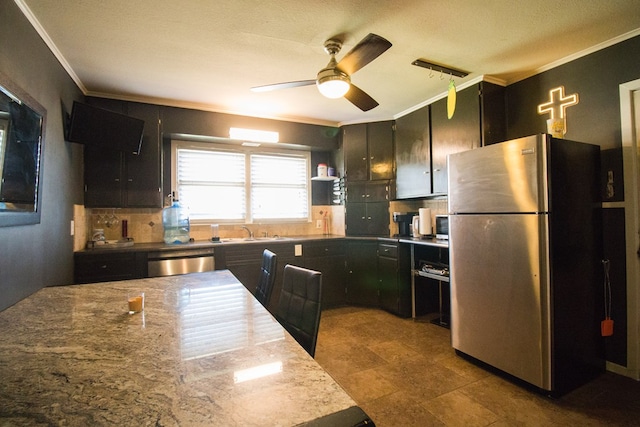 kitchen with crown molding, dishwashing machine, decorative backsplash, freestanding refrigerator, and dark cabinets