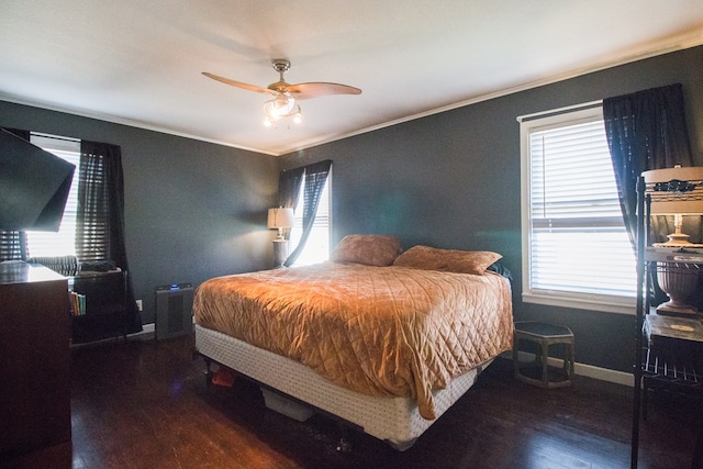 bedroom with ornamental molding, ceiling fan, baseboards, and wood finished floors