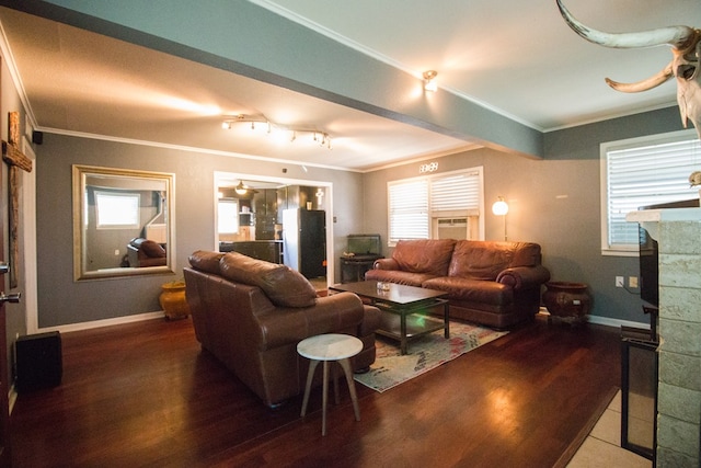 living area with wood finished floors, baseboards, and ornamental molding