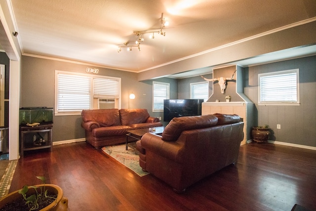 living room featuring plenty of natural light, crown molding, and wood finished floors