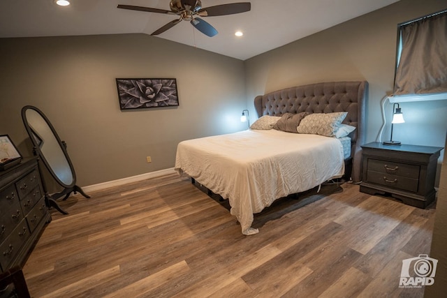 bedroom with lofted ceiling, hardwood / wood-style floors, and ceiling fan