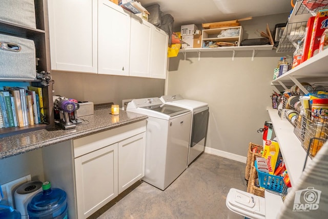 laundry area featuring cabinets and separate washer and dryer