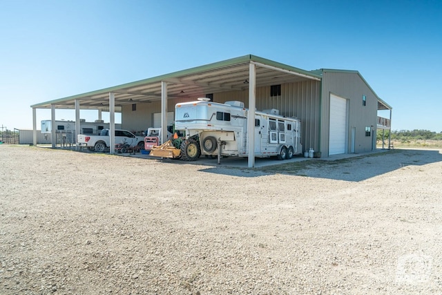 view of parking / parking lot featuring a garage