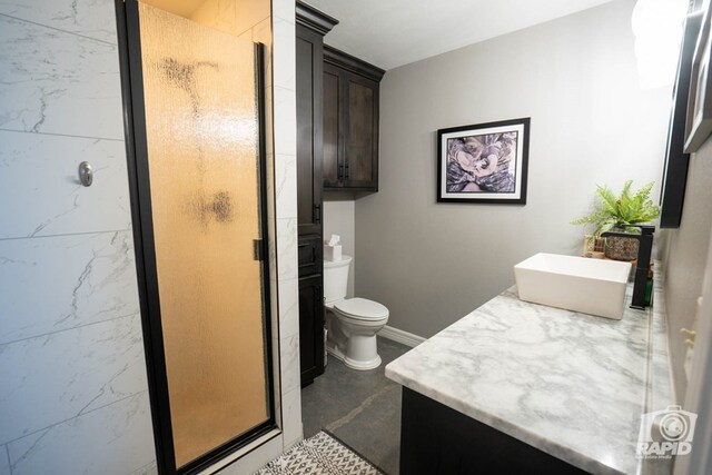 bathroom featuring vanity, a shower with shower door, and toilet