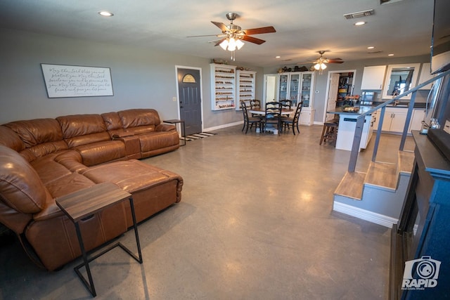 living room with concrete floors and ceiling fan