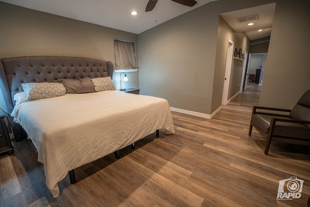 bedroom featuring dark hardwood / wood-style flooring, lofted ceiling, and ceiling fan