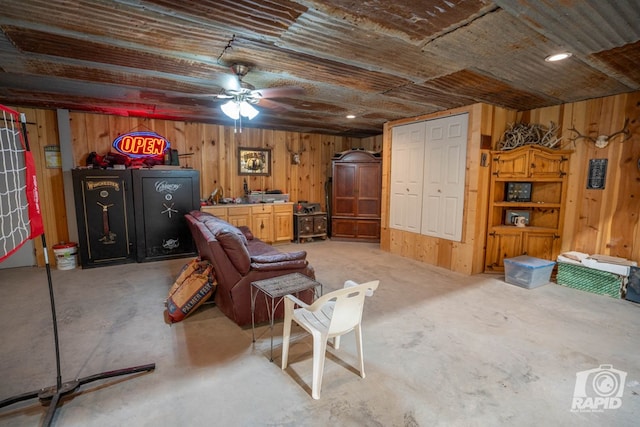 interior space featuring wood ceiling, wooden walls, and concrete floors