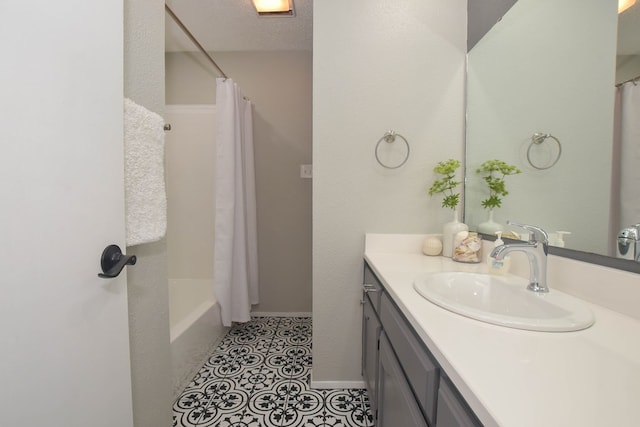 bathroom with vanity, tile patterned floors, a textured ceiling, and shower / tub combo with curtain