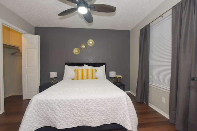 bedroom with ceiling fan, dark hardwood / wood-style flooring, and a textured ceiling