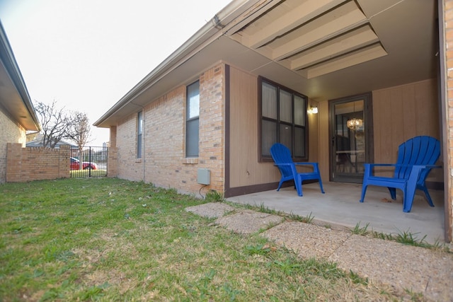 view of property exterior featuring a patio area and a lawn