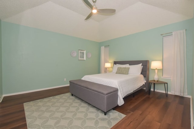 bedroom with baseboards, lofted ceiling, and wood finished floors