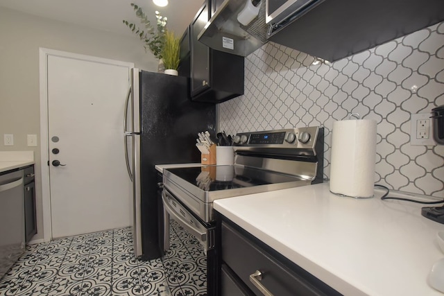 kitchen featuring appliances with stainless steel finishes, light tile patterned floors, and backsplash