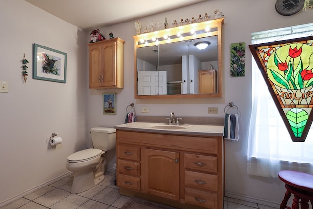 bathroom with vanity, toilet, and tile patterned flooring