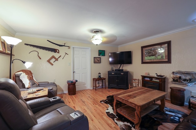 living room featuring crown molding and light hardwood / wood-style flooring