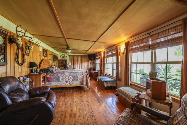 bedroom with wood ceiling, wood-type flooring, and wood walls