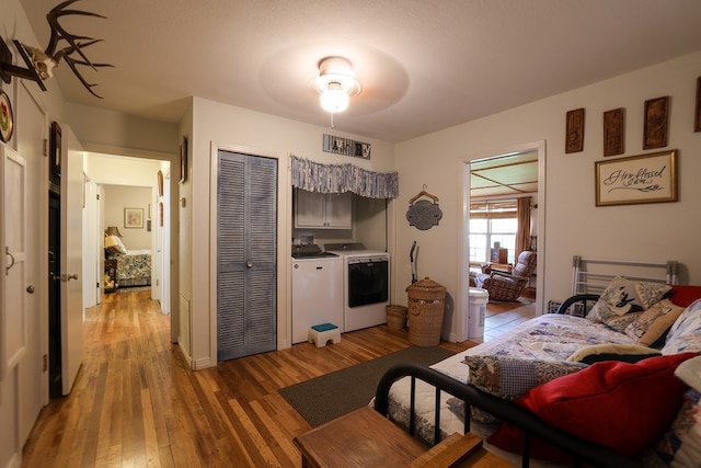 interior space with hardwood / wood-style floors, washer and clothes dryer, and ceiling fan