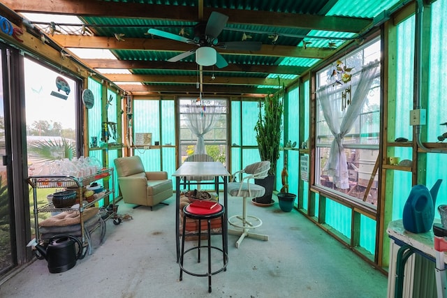 sunroom with a healthy amount of sunlight and ceiling fan