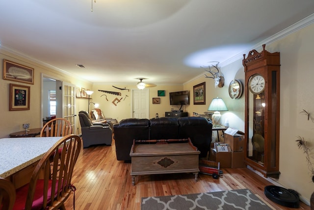 living room featuring ornamental molding, ceiling fan, and light hardwood / wood-style floors