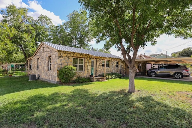 view of front facade with a carport, a front lawn, and central air condition unit