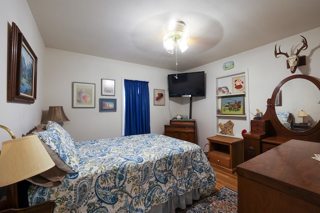 bedroom with hardwood / wood-style flooring and ceiling fan