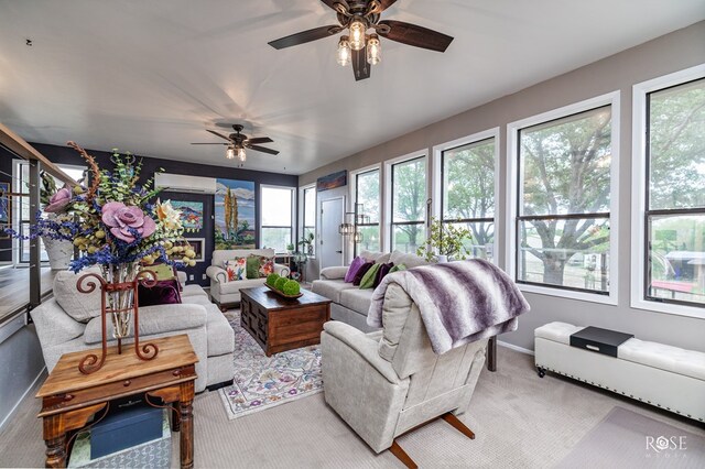 sunroom / solarium featuring a wall unit AC and ceiling fan