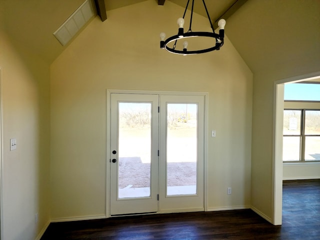 doorway featuring lofted ceiling, visible vents, dark wood-type flooring, and a notable chandelier