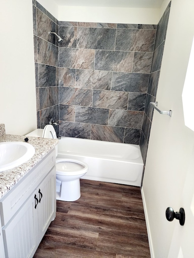 bathroom with shower / bathtub combination, vanity, toilet, and wood finished floors