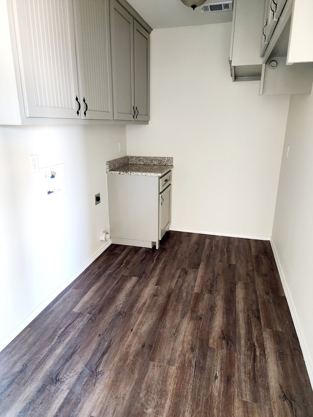 clothes washing area featuring hookup for a washing machine, cabinet space, electric dryer hookup, and dark wood-style floors