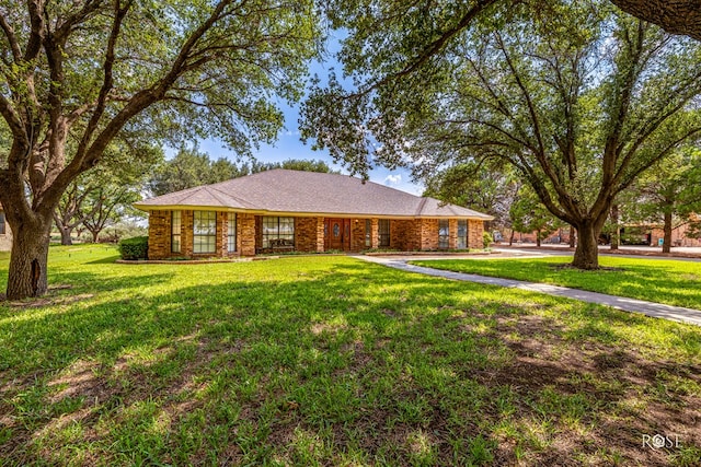 single story home with brick siding and a front yard