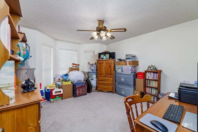 bedroom with carpet floors, ceiling fan, and a textured ceiling