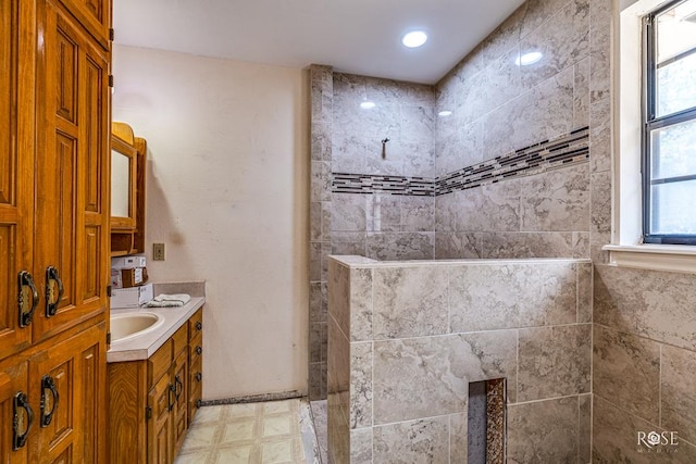 full bath featuring walk in shower, vanity, and tile patterned floors