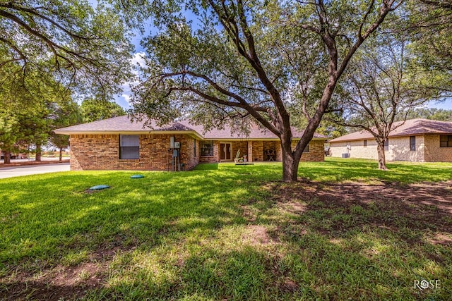 single story home with a front yard and brick siding