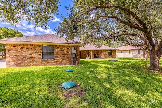 view of front of house with brick siding and a front yard