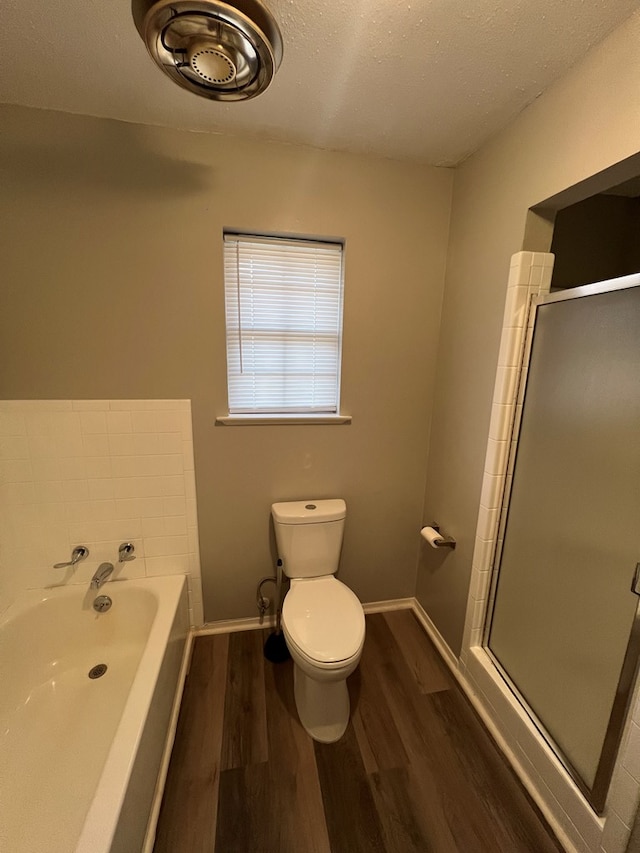 3222 Southland Blvd, San Angelo, TX 76904 - full bath featuring wood finished floors, a shower stall, and a garden tub