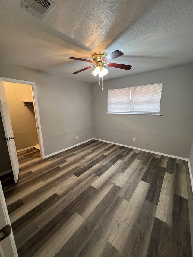 3222 Southland Blvd, San Angelo, TX 76904 - unfurnished bedroom featuring a textured ceiling, wood finished floors, and ceiling fan