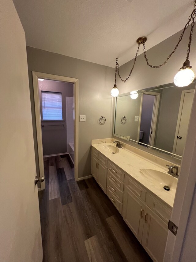3222 Southland Blvd, San Angelo, TX 76904 - bathroom with wood finished floors and double vanity