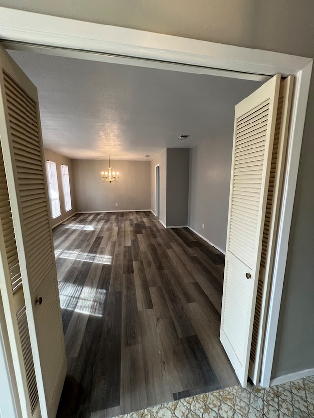 3222 Southland Blvd, San Angelo, TX 76904 - unfurnished living room featuring a chandelier and wood finished floors